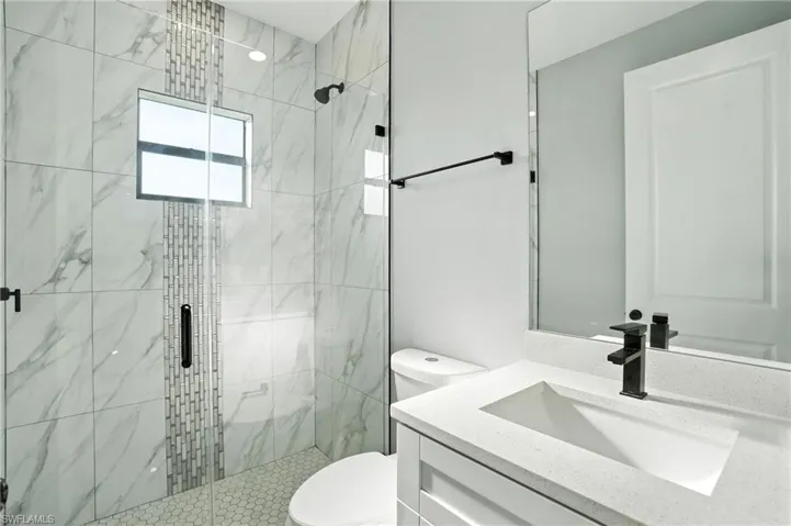 Bathroom with vanity and a shower stall