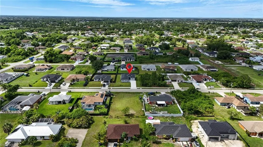 Aerial overview of property's location with nearby suburban area