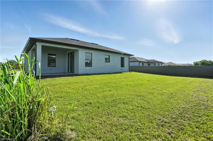 Rear view of house featuring stucco siding