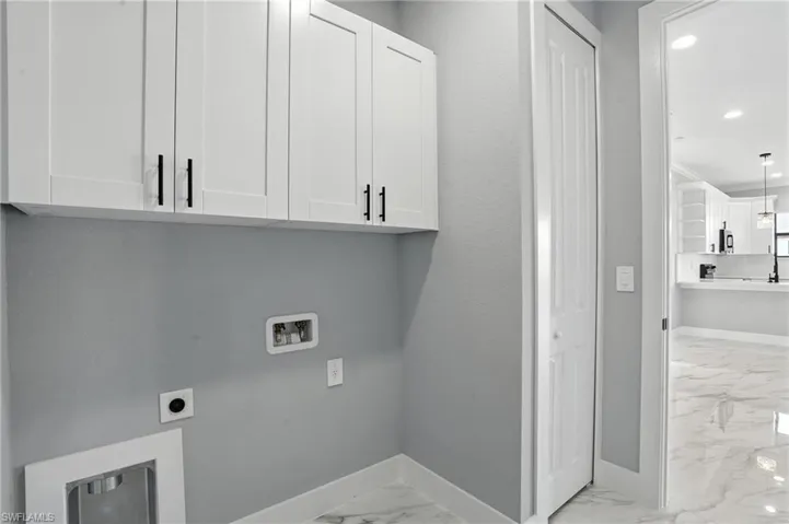 Washroom with light marble finish flooring, hookup for a washing machine, cabinet space, electric dryer hookup, and recessed lighting