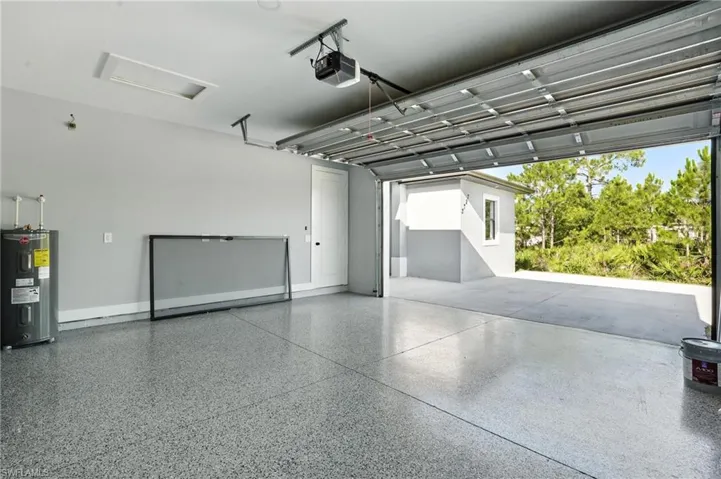 Garage with electric water heater and a garage door opener