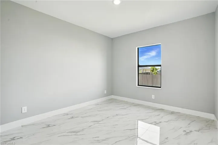 Unfurnished room featuring light marble finish floors and recessed lighting