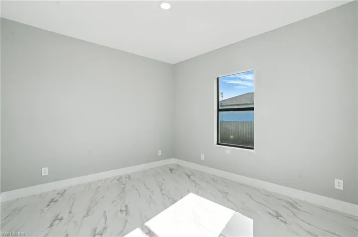 Spare room with marble finish floors and recessed lighting