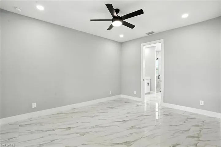 Unfurnished room with a ceiling fan, recessed lighting, light marble finish flooring, and a smoke detector