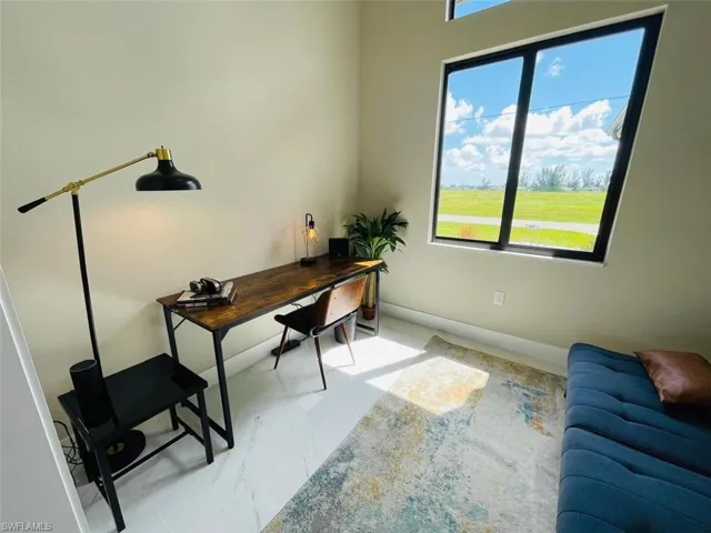 Office with baseboards and light marble finish floors