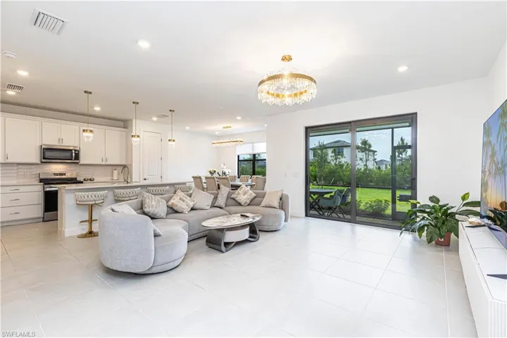 Living area featuring a chandelier, recessed lighting, and light tile patterned floors