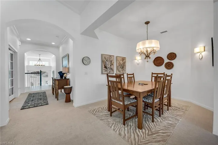 Formal dining room with high ceilings and natural light.