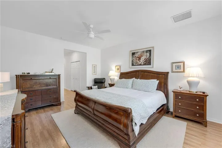 Large primary bedroom with lake views and direct lanai access.