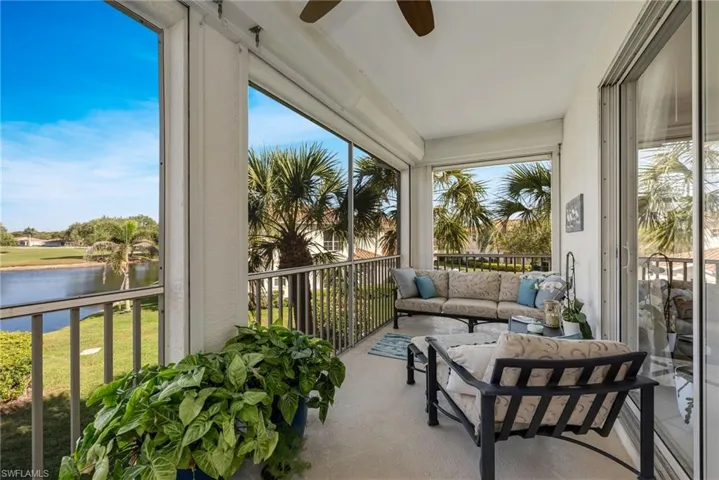 Screened-in lanai with beautiful lake views and space to relax.