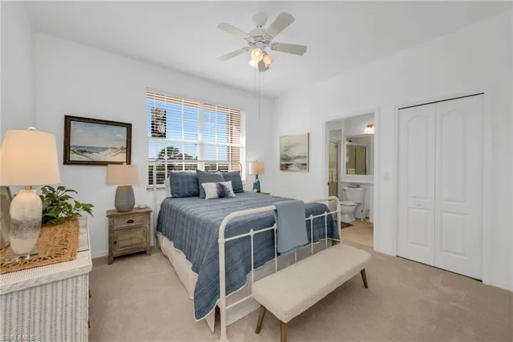 Comfortable guest ensuite with plush carpeting, large closet, and plenty of natural light.
