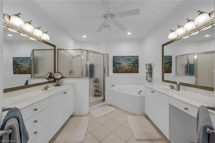 Primary bathroom with dual vanities and expansive counter space.