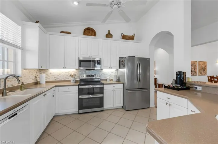 Modern kitchen with stainless steel appliances and ample cabinet space.