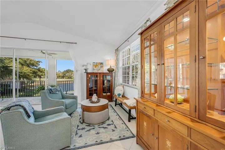 Open concept living area with large windows overlooking the lake.