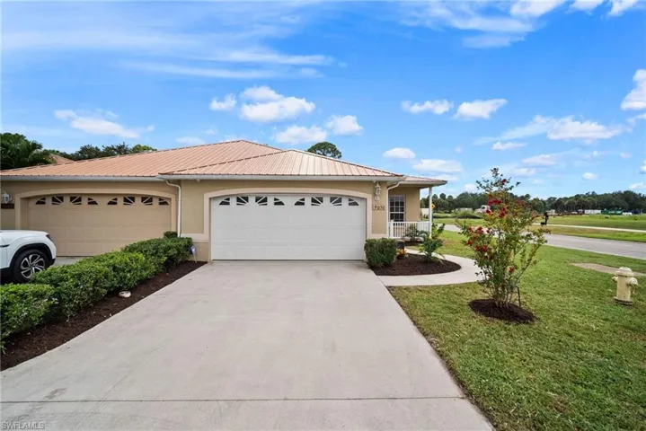View of front of house featuring a garage and a front yard
