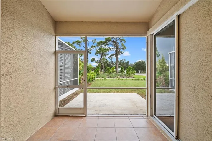 Doorway with light tile patterned floors