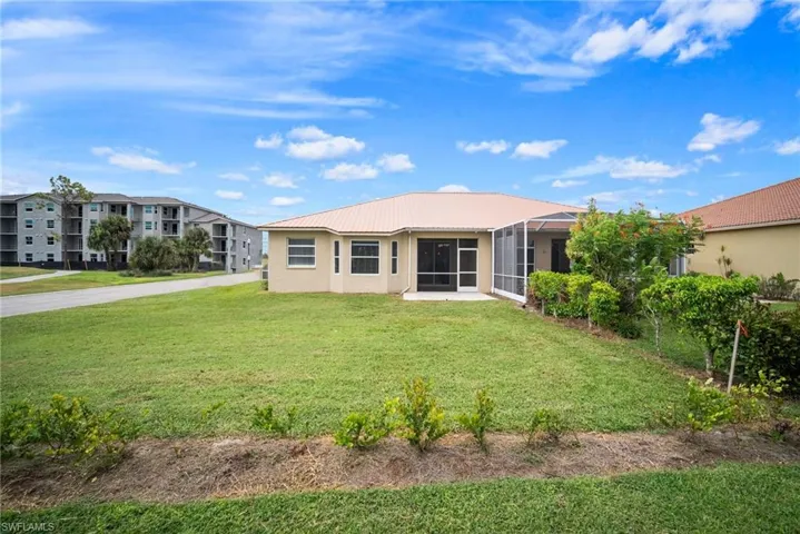 Back of property featuring a yard