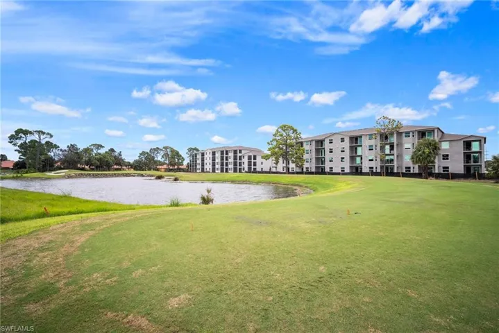 View of property's community featuring a lawn and a water view
