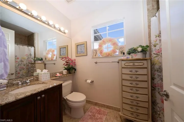 Full bath featuring a shower with curtain and vanity