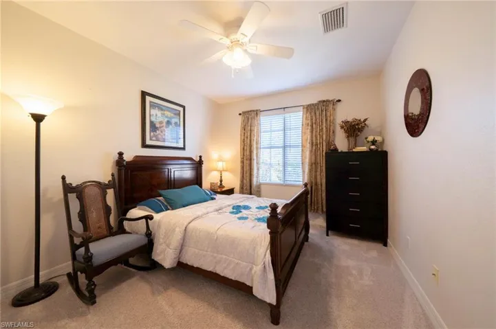 Carpeted bedroom featuring baseboards and a ceiling fan