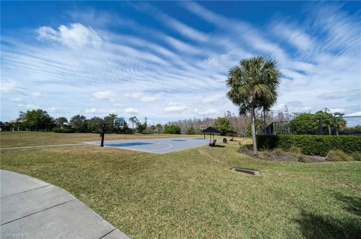 View of basketball court featuring community basketball court and a lawn