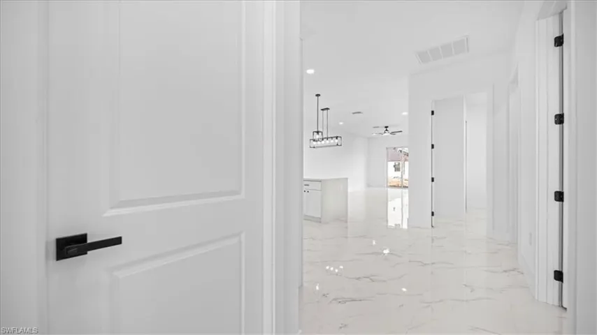 Corridor with recessed lighting and light marble finish flooring