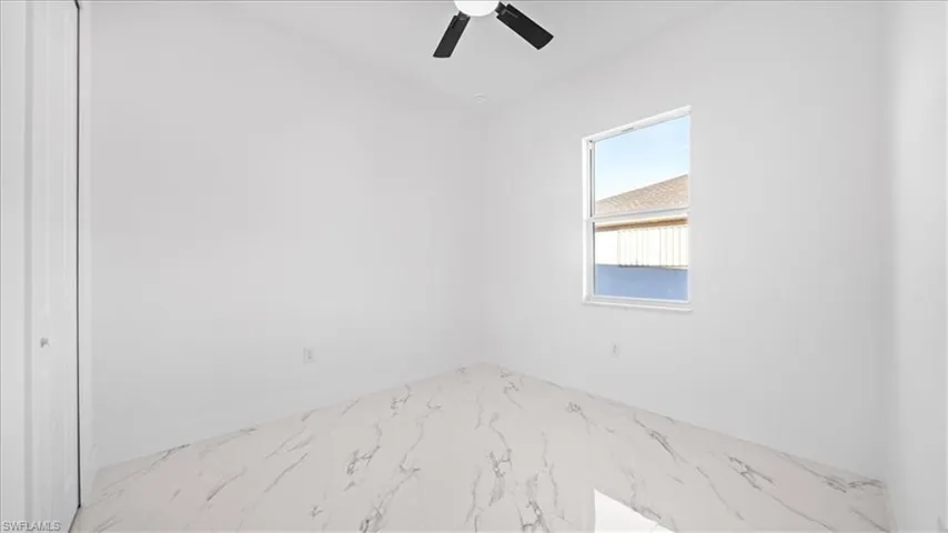 Spare room with ceiling fan