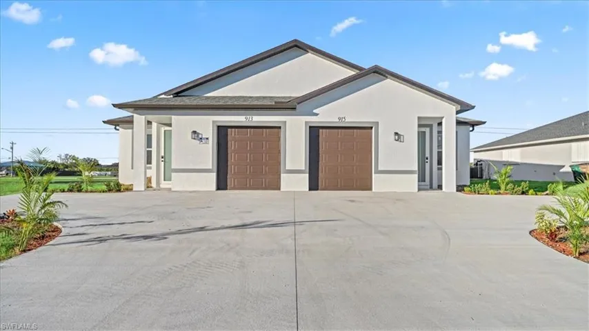 Ranch-style house with stucco siding, concrete driveway, and a garage