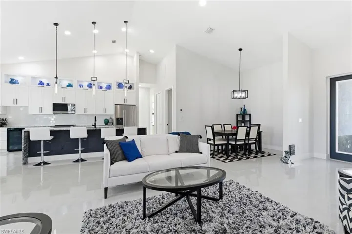Living room featuring vaulted ceiling and recessed lighting