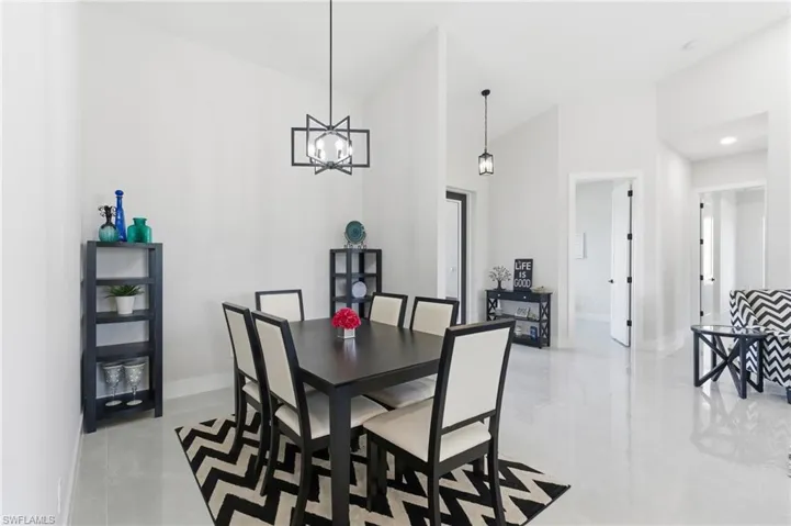 Dining space with vaulted ceiling and hanging lights