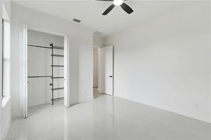 Guest bedroom 2 featuring ceiling fan and a closet