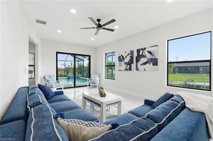 Living room with a sunroom, ceiling fan, recessed lighting and ample natural light