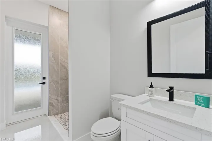 Full pool bath featuring walk in shower and vanity