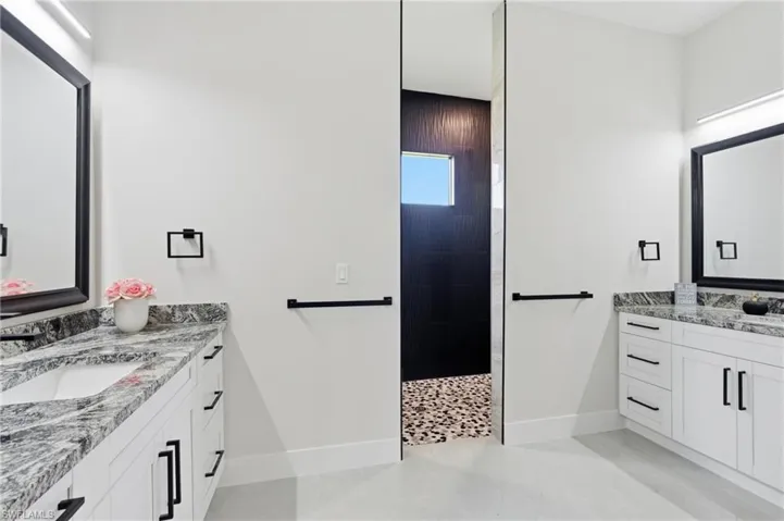 Primary bathroom with two vanities and walk in shower