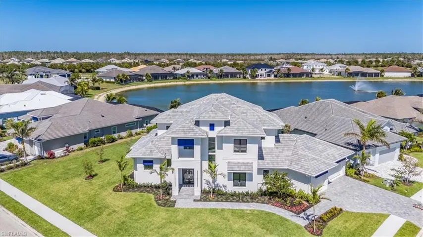 Aerial view of residential area featuring a large body of water