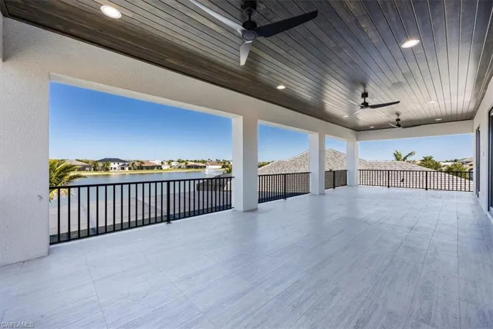 View of patio featuring ceiling fan, a water view, and a residential view