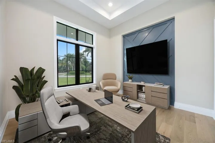 Office area featuring light wood finished floors and recessed lighting