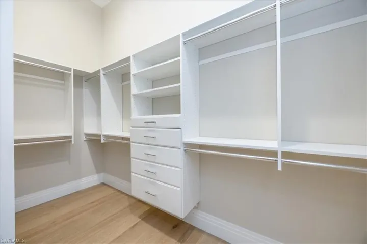 Spacious closet with light wood-type flooring
