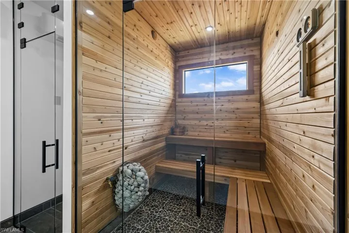 Relaxing sauna / steam room featuring wood walls and wood ceiling