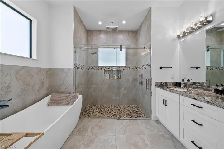 Full bathroom featuring a soaking tub, vanity, a shower stall, and recessed lighting