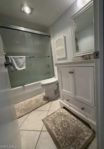 White vanity with shaker-style cabinetry, a speckled countertop, and chrome hardware