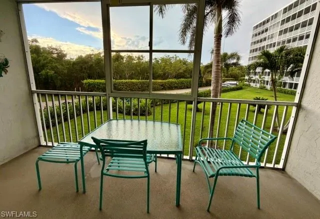 Screened outdoor patio with a textured concrete floor