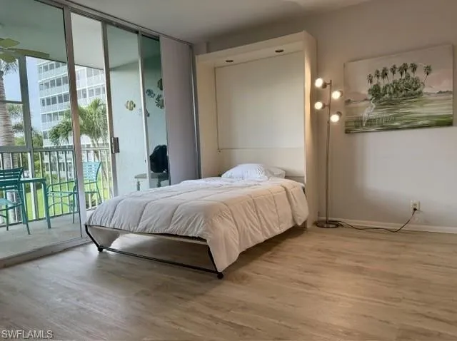Light wood-finish flooring complements the neutral wall color
