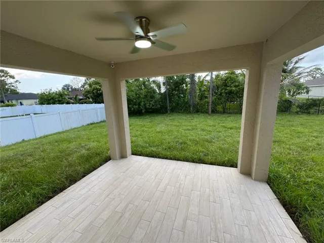 Wooden terrace with ceiling fan and a patio