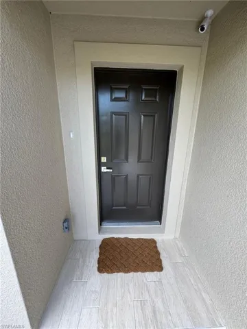 Doorway to property with stucco siding