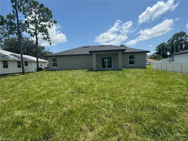 Rear view of property with stucco siding