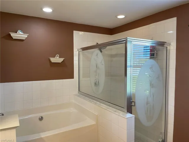 Bathroom featuring shower with separate bathtub