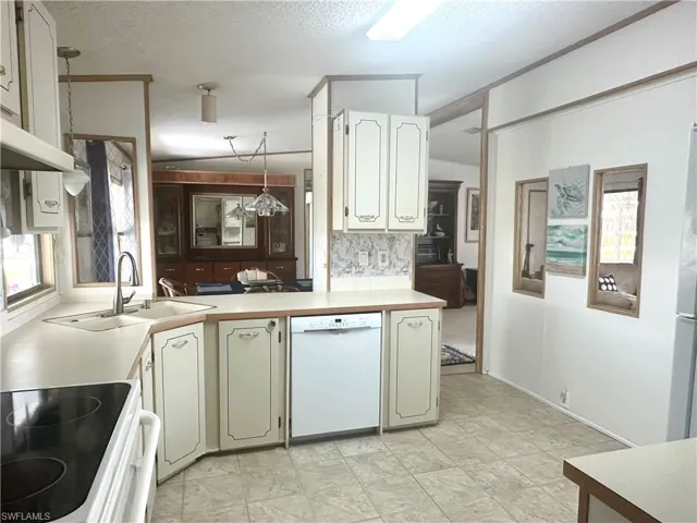 Kitchen, featuring 3 transom windows & the walkway leading to the dining room.