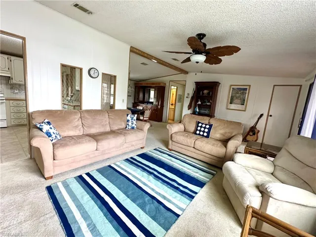 Living Room, kitchen doorway, dining room, and guest bedrooms/bathroom walkway.