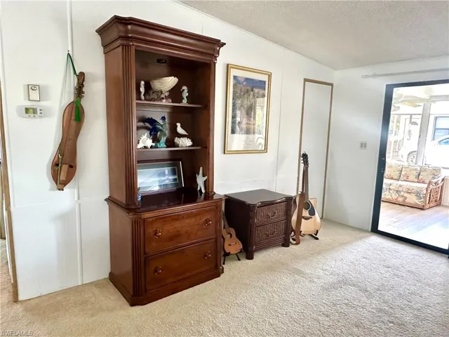 Living room and sliding door leading to the Lanai/Sun room.
