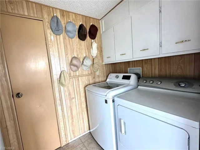 Laundry room with a washer, dryer, and coat closet.
